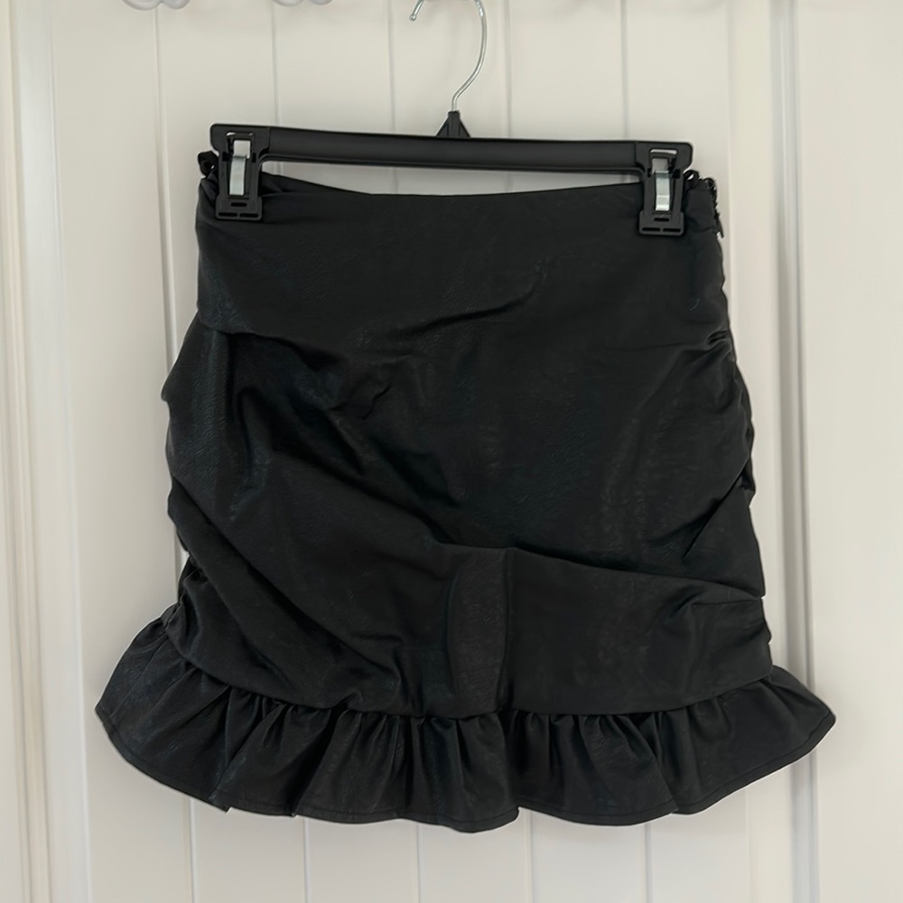 Black faux leather mini skirt. Never been worn.